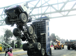 A tipper hangs precariously under a bridge near Biza.