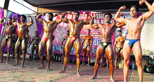 Bodybuilders pose during the Punjab Classic and third Mr Dera Bassi Body Building Championship on Friday. 