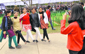 A girl clicks pictures of her friends.
