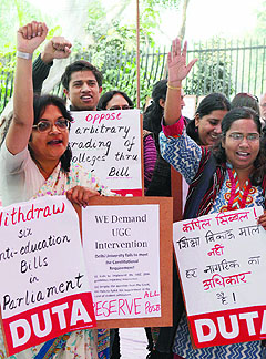 Teachers protest against the UGC to press for their demands in New Delhi on Friday.
