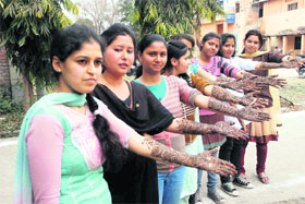 Girls participate in a mehndi competition during the union week at DAV PG College in Dehradun on Friday.