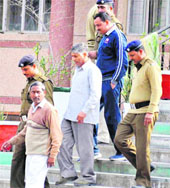 The accused in the murder case of an RTI activist being taken into judicial custody in Hardiwar on Friday.