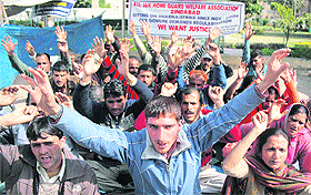 Members of the J&K Home Guard Welfare Association protest in support of their demands at Mubarak Mandi in Jammu on Friday.