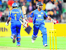 Sri Lankas Nuwan Kulasekara (R) celebrates hitting the winning runs against Australia with teammate Thisara Perera (L) in Hobart on Friday. Sri Lanka won the match by three wickets. 