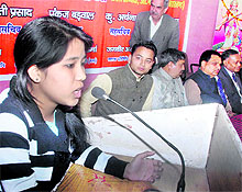 A student participates in a debate competition at DAV College in Dehradun on Saturday