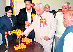 An educationist lights a traditional lamp before the start of a national seminar at the Swami Darshanand Institute of Management and technology in Haridwar on Saturday
