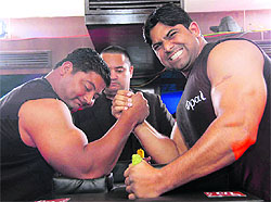 Two arm wrestlers in a bout in the National Arm Wrestling League in Dehradun on Saturday