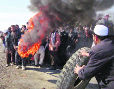 Protesters burn tyres during a demonstration at a US military base in Kabul on Saturday. 