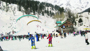 Tourists ski in the Solang valley, 13 km from Manali, on Sunday