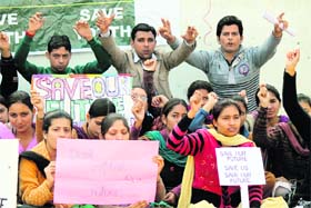 Members of the National Youth Corp stage a protest in support of their demands in Jammu on Sunday