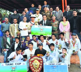 Players of the RCC pose with the JPL-I trophy at Reasi on Sunday. Also seen are RS Chib, Minister for Youth Services and Sports, and officials of the Army and civil administration