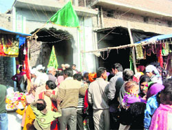 Devotees wait for their turn to pay their obeisance at religious place in Jagraon. 