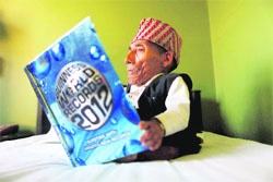 Nepals Chandra Bahadur Dang looks at a copy of the Guinness World Record book in Kathmandu on Sunday