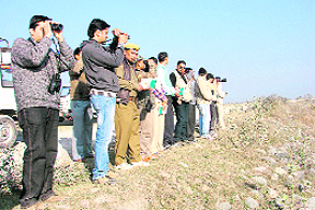 Participants at a bird-watching camp organised by the eco-tourism wing of the state Forest Department at Chhoti Haldwani near the Jim Corbett National Park on Monday. 