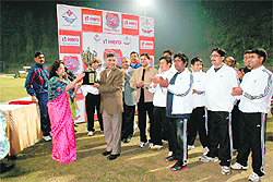 State DGP JS Pandey receives the winning trophy of a friendly cricket match between IPS and IAS officers played in Dehradun on Sunday.