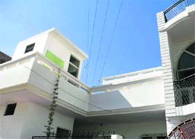 High-tension wires pass over the terrace of a house in Fatehabad
