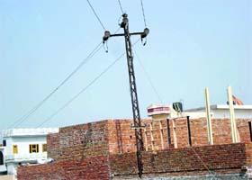 A house being constructed under a transmission line in Friends Colony, Kaithal