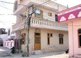 Electric wires on a pole adjacent to the terrace of a building in New Colony, Kurukshetra