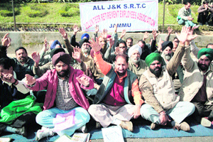 Members of the All J&K SRTC Volunteer Retirement Employees Association stage a protest in support of their demands in Jammu on Monday. 