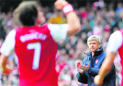 Arsene Wenger (R) applauds Tomas Rosickys goal against Tottenham Hotspurs in London on Sunday. 