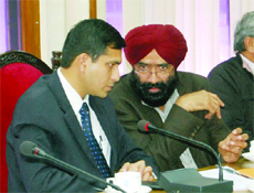 Deputy Commissioner Rajat Agarwal and Civil Surgeon Dr Manjit Singh Randhawa share a point during a meeting of NHRM in Amritsar on Tuesday. 