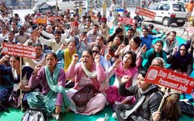 Protesting bank employees sit on a dharna near the Union Bank at Mall road on Tuesday