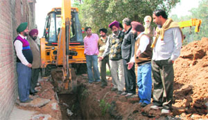 Industrialists stop the work of a GMADA contractor at Phase IX, Industrial Area, Mohali, on Tuesday.