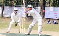 A batsman plays a shot in the inter-department cricket tournament in Dehradun 