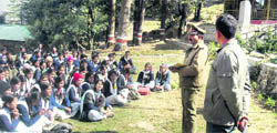Deputy Forest Ranger M Gairola addresses students from Government Inter-College, Ghorakhori, at the eco park at Dhanaulti.