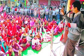 Members of trade unions hold a protest rally at Gandhi Chowk in Hamirpur on Tuesday
