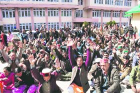 Members of the State Electricity Board Employees Union raise slogans in support of their demands at Kumar House in Shimla on Tuesday