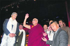 The Dalai Lama waves at delegates during an IAPSM Conference in the Sobha Singh Auditorium at the medical college in Tanda on Tuesday