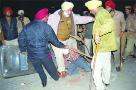 The police tries to control protesters on the Jalandhar-Amritsar national highway near Sekhwan Khoo locality on Tuesday