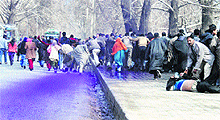 An activist lies injured along the road after the police resorted to lathicharge and use of water cannon against protesters in Srinagar on Tuesday. 