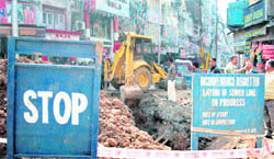 Digging work for laying sewer lines undertaken by the National Buildings Construction Corporation at the City Chowk in Jammu.