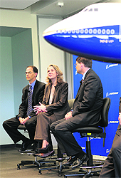 Boeing executives (L to R) Steve Taylor, Elizabeth Lund and Bruce Dickinson speak to the media about the delivery of the first 747-8 Intercontinental plane to an undisclosed VIP customer during a ceremony at Paine Field in Everett, Washington on Wednesday