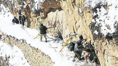 ITBP jawans tie ropes to cross the track from Gunji to Garbiyang in Pithoragarh.