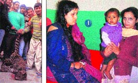 Villagers with the carcass of a leopard in Hamirpur on Wednesday; and (right) a woman and her child in a hospital after they were attacked by the animal
