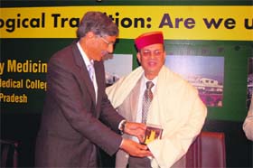 Dr Anil Chauhan, Principal, DRPGMC, Tanda, honours Dr Vishwa Mohan Katoch, secretary, Central Department of Health Research, in the college on Wednesday