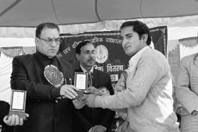 BJP MLA Suresh Bhardwaj gives away a prize to a student during the annual function of Government Senior Secondary School, Lalpani, in Shimla on Wednesday