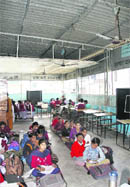Students study by sitting on the ground in their class at Government Elementary School, Kabir Nagar, in Jalandhar