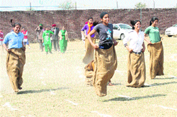 Girls take part in a sack race during athletics meet organised at Mata Ganga Khalsa College. 