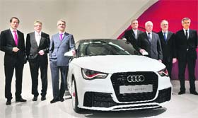 Members of the board of management of German luxury carmaker Audi (L-R) Axel Strotbek, Thomas Sigi, CEO Rupert Stadler, Ulf Berkenhagen, Michael Dick, Frank Dreves and Peter Schwarzenbauer pose next to an Audi A1 Quatro model during the company's annual press conference in Ingolstadt, Bavaria, on Thursday