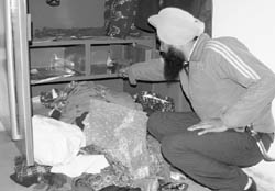 A man shows a ransacked almira at a house in Shahi Majri