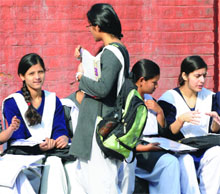Students revise for their CBSEClass X examination at the last moment before entering an examination hall in New Delhi on Thursday.