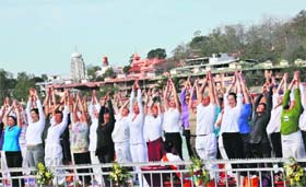 Foreign yoga gurus practise along the Ganga ghat in Rishikesh on Thursday