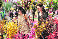 Girls look at flowers at the Gandhi Shilp Bazaar in Gurgaon.