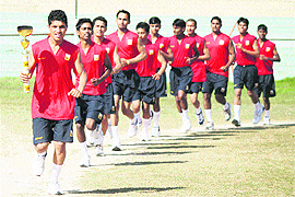 Athletes carry a symbolic torch in support of Indian players taking part in London Olympics 2012, at MA Stadium in Jammu on Thursday. 