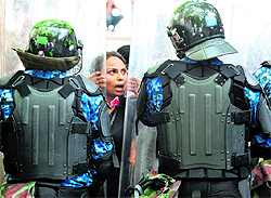 Policemen stand guard as a protester shouts slogans in Male on Thursday