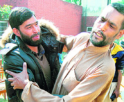 Syed Gulam Nabi Shah (right) hugs his brother in Amritsar.